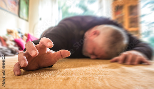 a man lies unconscious in his apartment
 photo