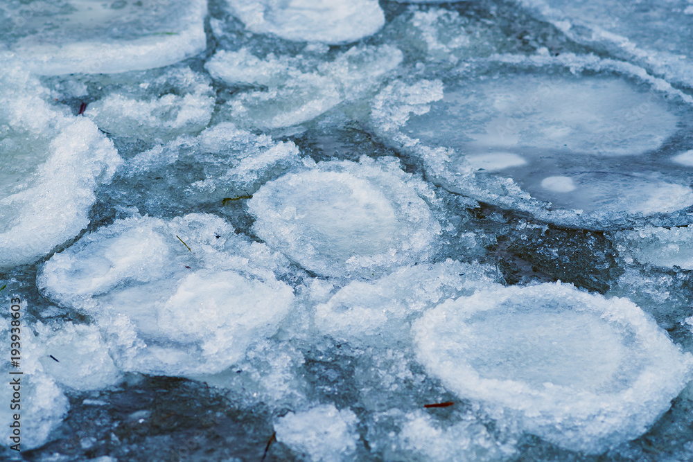 Small ice floes float in the cold water