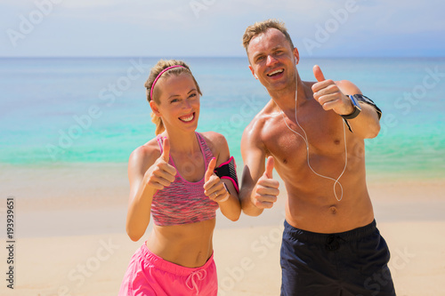 Happy fitness people on the beach