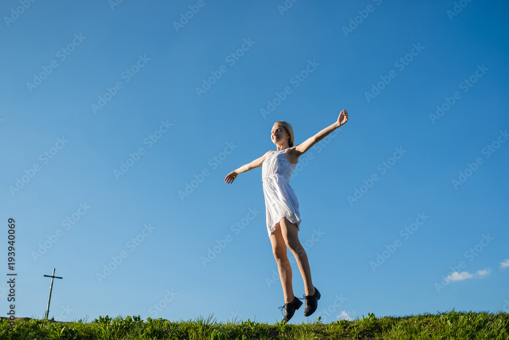 full lenth portrait of young woman is jumping on the meadow full lenth portrait of young woman is jumping on the meadow