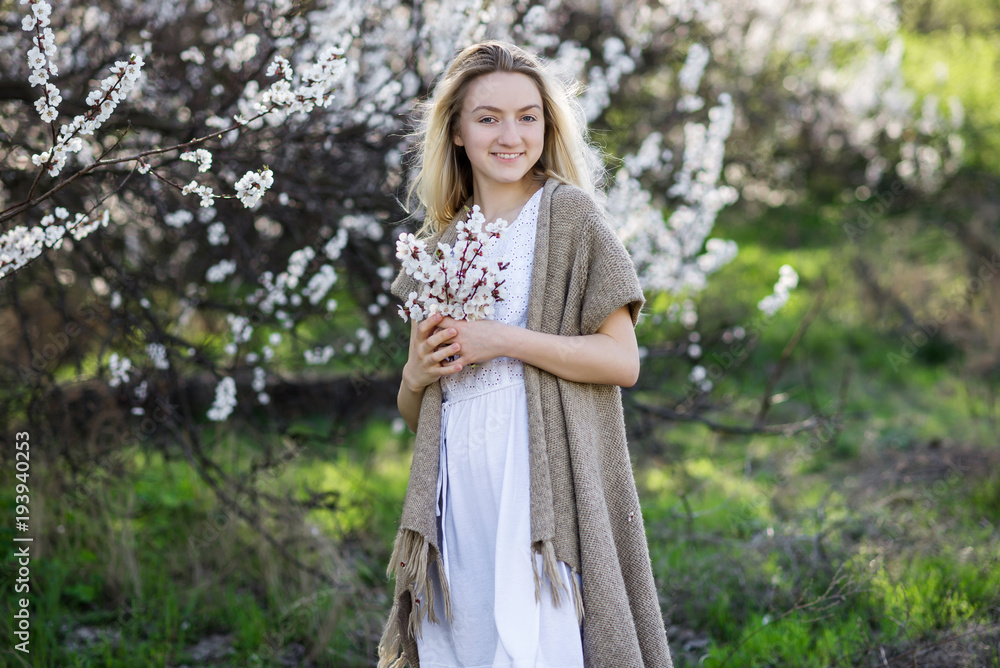 Teenage girl in blooming apricot garden Teenage girl in blooming apricot garden