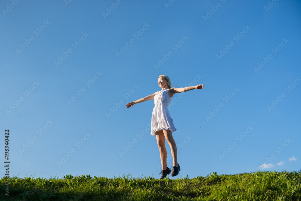 full lenth portrait of young woman is jumping on the meadow full lenth portrait of young woman is jumping on the meadow