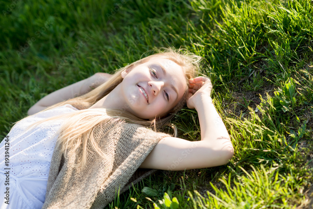 teen girl lays on the grass teen girl lays on the grass