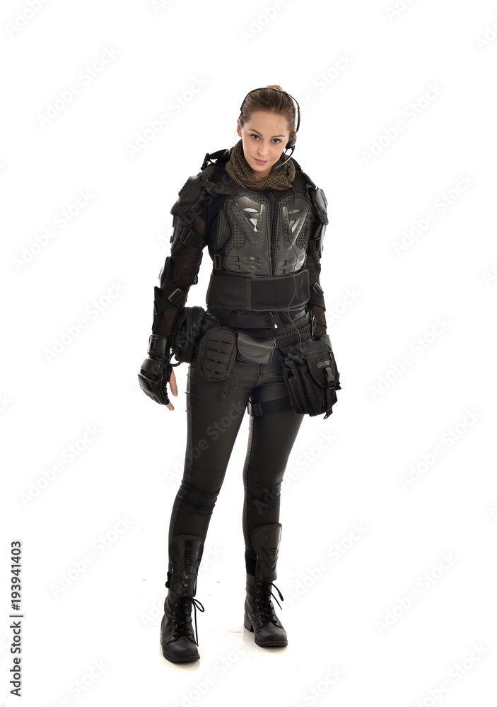 full length portrait of female soldier wearing black tactical armour, isolated on white studio background. full length portrait of female soldier wearing black tactical armour, isolated on white studio background.