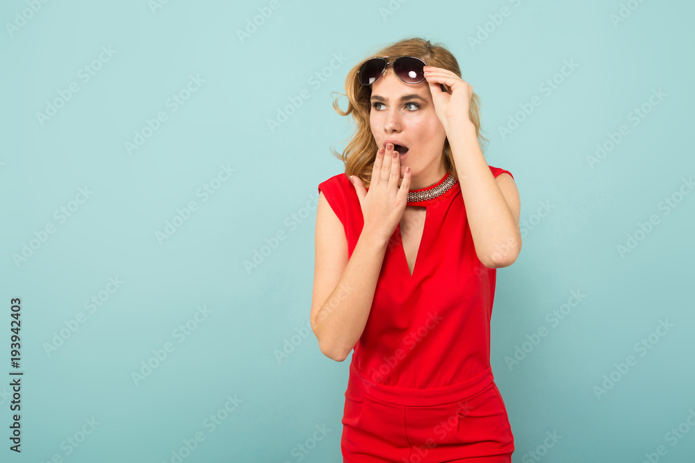 Shocked woman in red overalls and sunglasses Shocked woman in red overalls and sunglasses
