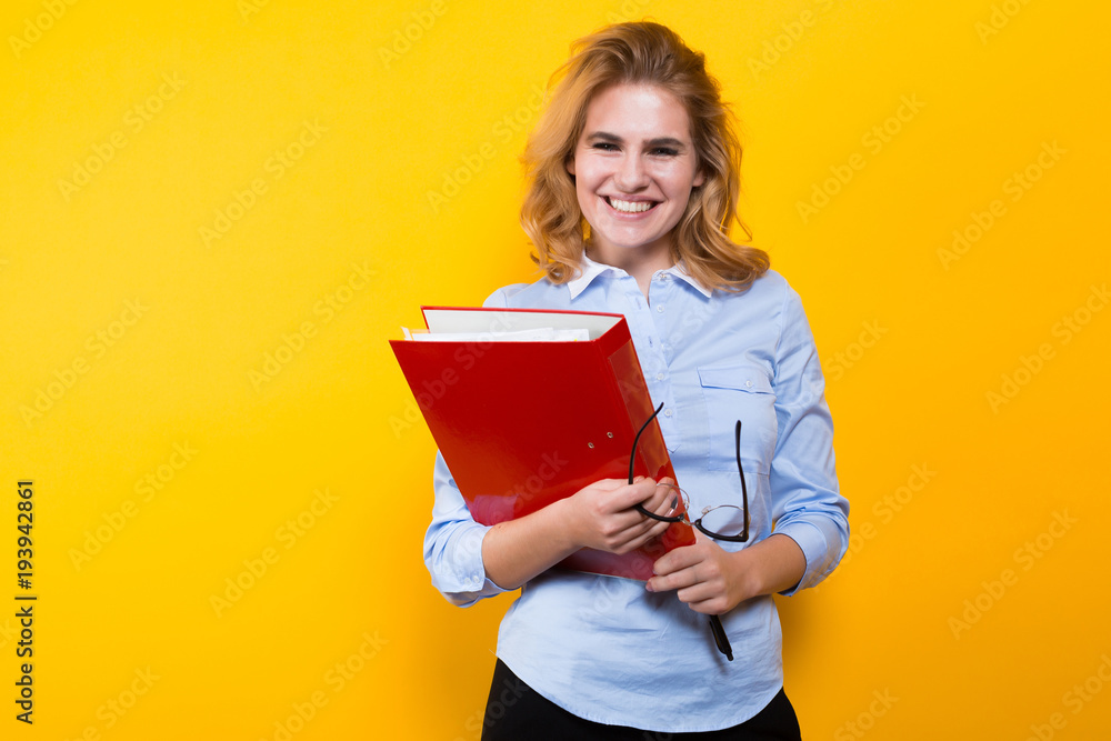 Fototapeta premium Smiling woman with big folder