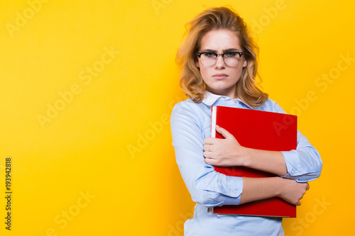 Unhappy woman with big folder