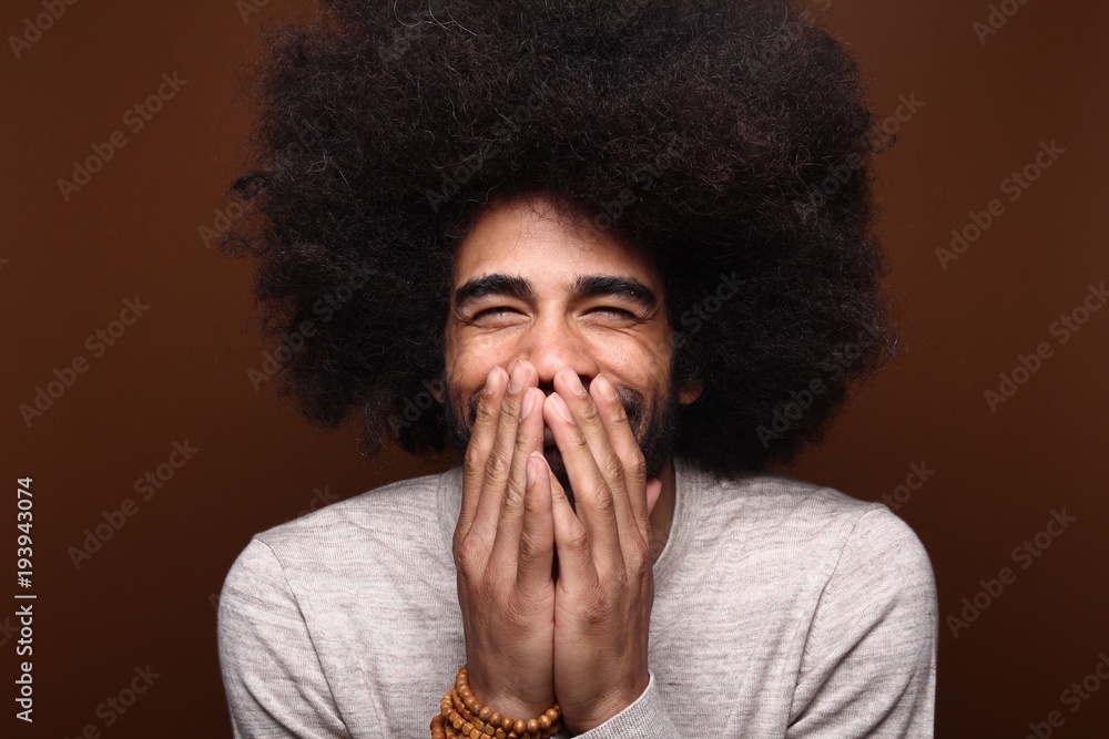 Afro man in front of a brown background Afro man in front of a brown background