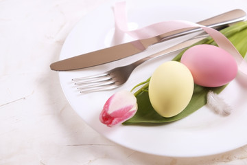 Easter laying table appointments, table setting options. Silverware, tableware items with festive decoration. Fork, knife and flowers. Happy easter holiday.