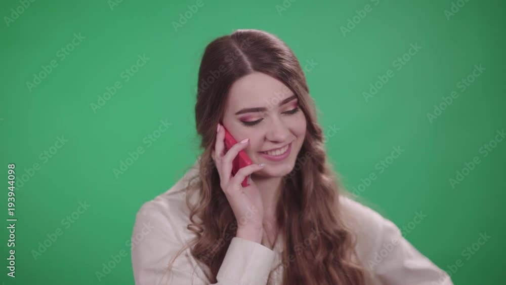 Girl talking on a mobile phone on chromakey background, emotion.
Girl talking on a mobile phone on chromakey background, emotion.