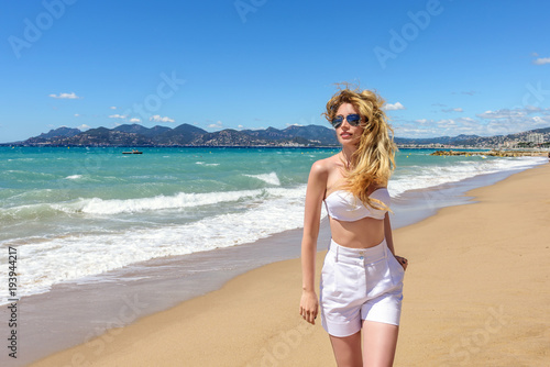 Woman portrait at the beach in Cannes, France. Sunny day. Beautiful Seaside b...