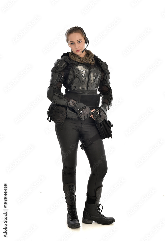 full length portrait of female soldier wearing black tactical armour, isolated on white studio background. full length portrait of female soldier wearing black tactical armour, isolated on white studio background.