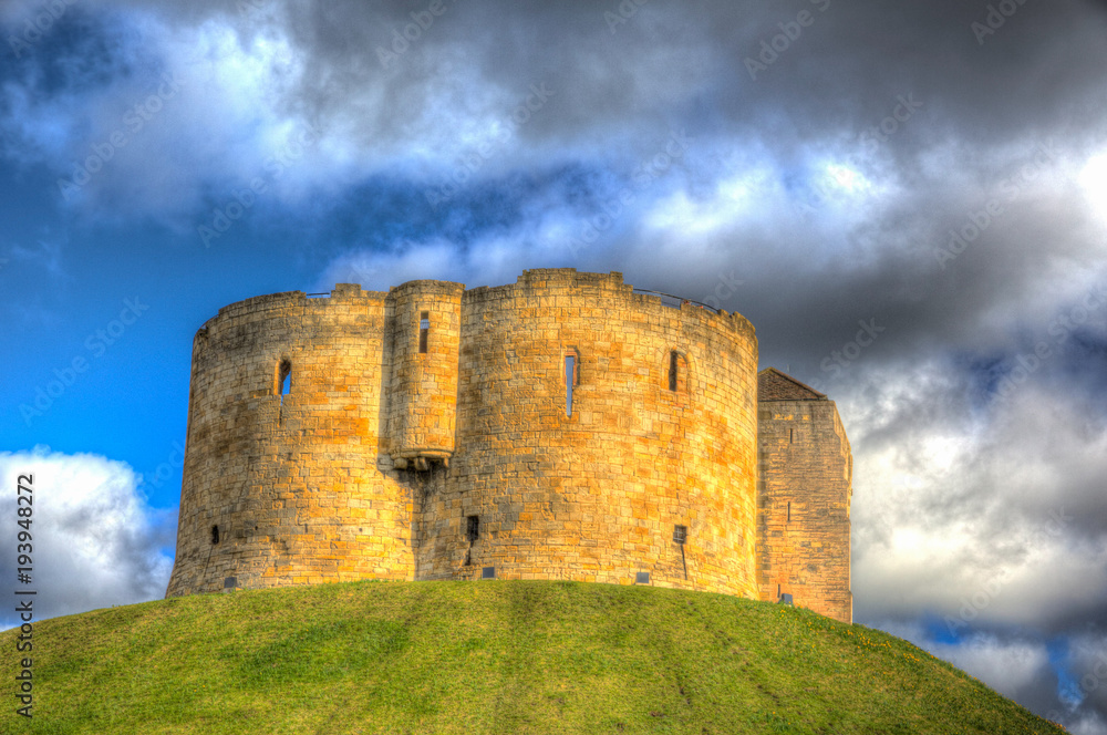 York UK Clifford`s Tower tourist attraction 13th century medieval castle in colourful HDR