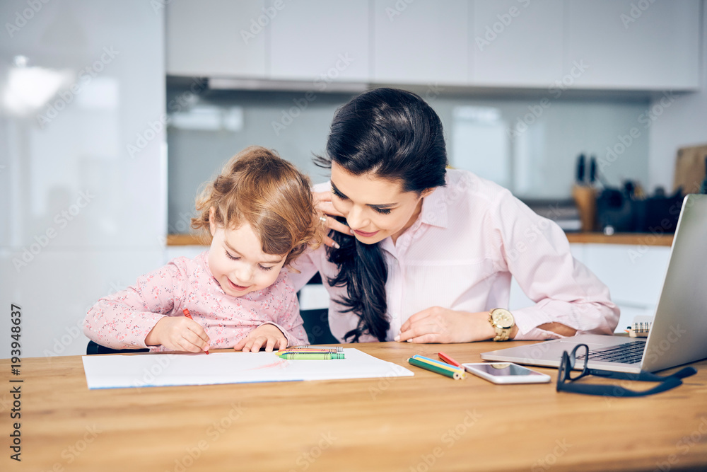 Mother working from home trying to keep her child busy Mother working from home trying to keep her child busy