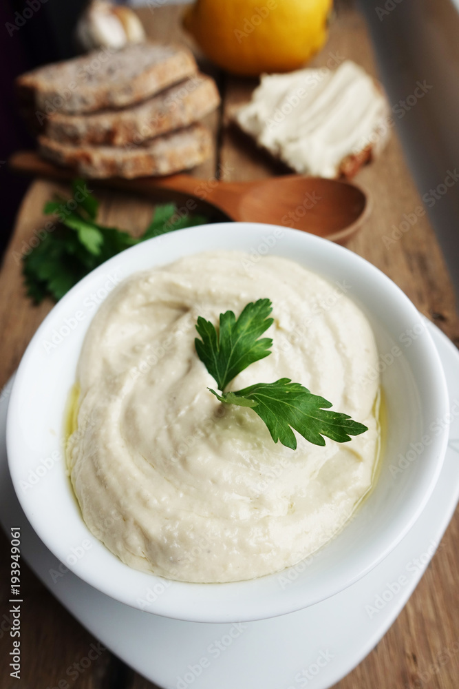 Tasty chickpeas hummus with olive oil, garlic and parsley, served on fresh wholegrain bread
Tasty chickpeas hummus with olive oil, garlic and parsley, served on fresh wholegrain bread