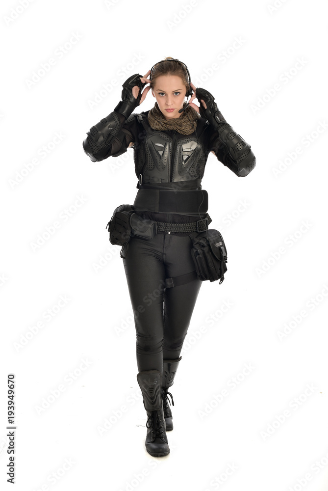 full length portrait of female soldier wearing black tactical armour, isolated on white studio background. full length portrait of female soldier wearing black tactical armour, isolated on white studio background.
