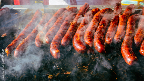 Grilled sausage on barbecue, grill. Shallow depth of field.