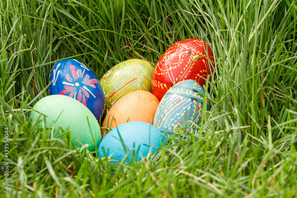 Painted Easter eggs in spring green grass