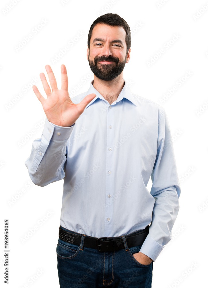 Handsome man with beard counting five Handsome man with beard counting five