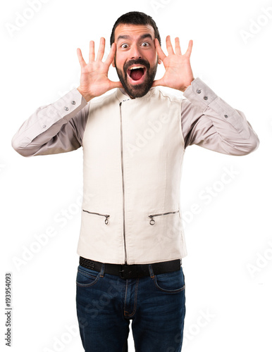 Handsome man with vest making surprise gesture on isolated white background