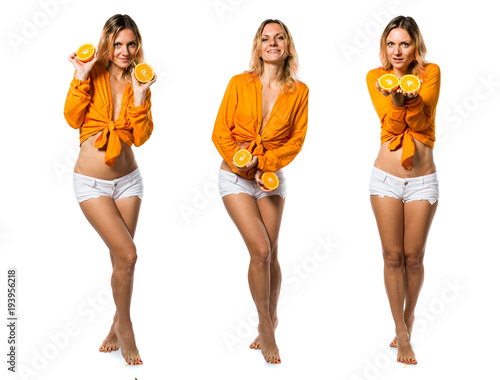 Beautiful blonde woman holding oranges