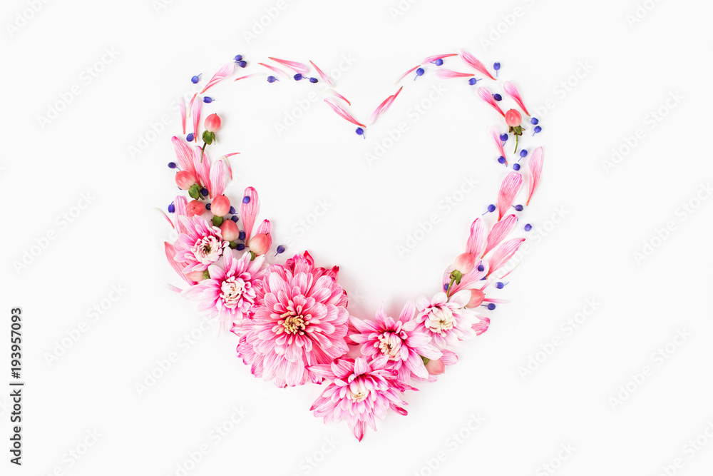Beautiful floral arrangements. Pink chrysanthemums in the shape of heart frame on white background. Flat lay, top view.