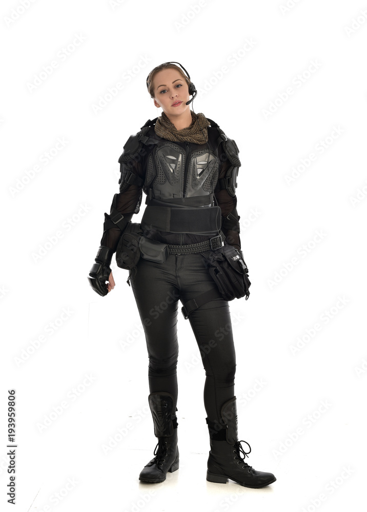 full length portrait of female soldier wearing black tactical armour, isolated on white studio background. full length portrait of female soldier wearing black tactical armour, isolated on white studio background.