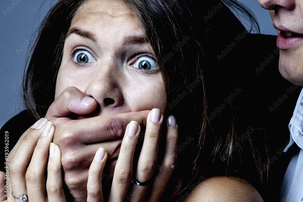 Gender terror and aggression man covers woman's mouth. (Fear, gender