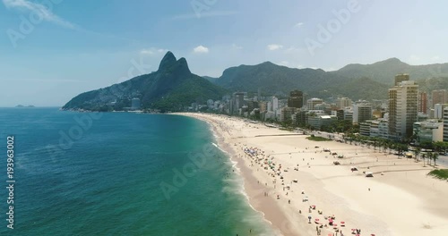 Aerial shot above Ipanema Beach at sunny summer day in Rio de Janeiro, Brazil. Light effect applied