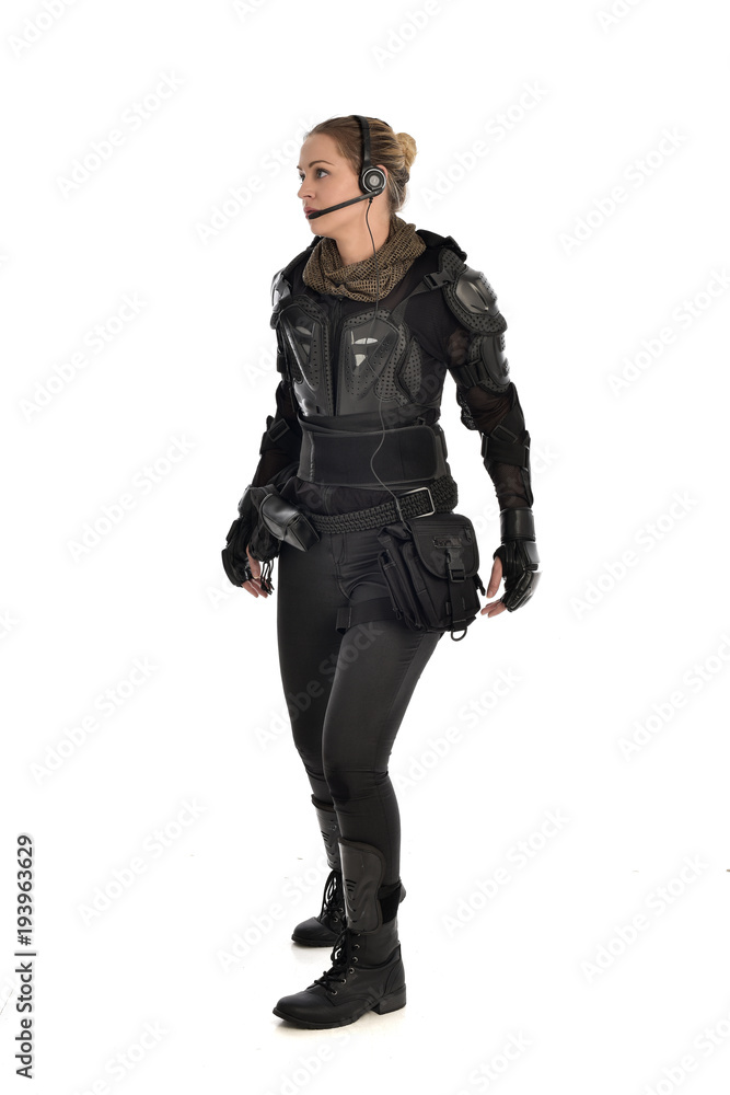 full length portrait of female soldier wearing black tactical armour, isolated on white studio background. full length portrait of female soldier wearing black tactical armour, isolated on white studio background.