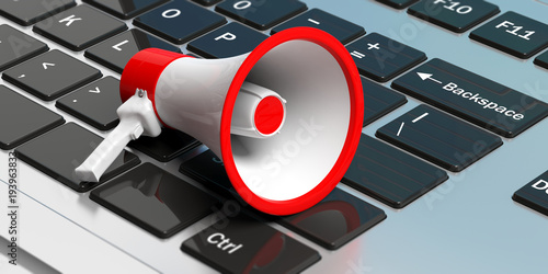 Megaphone on a laptop. White bullhorn with red details. 3d illustration photo