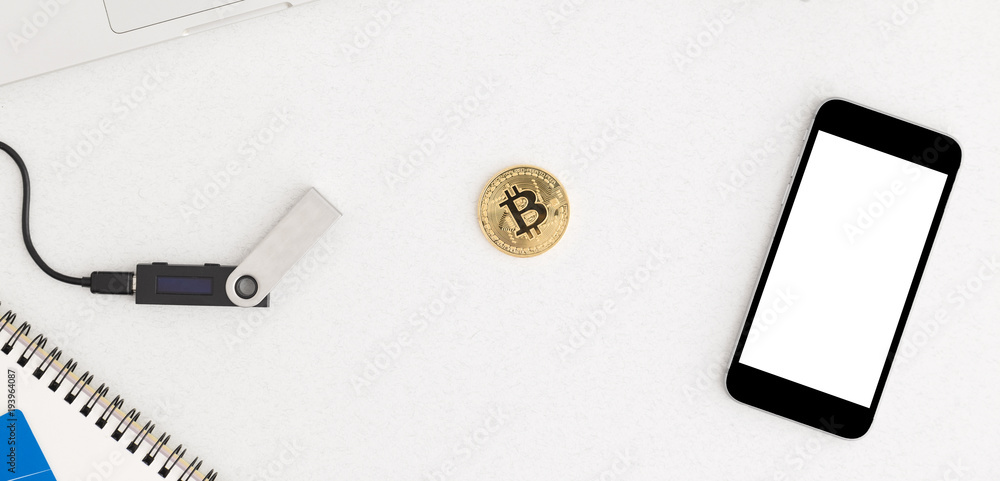 Digital ledger wallet for bitcoin and alternative coins payments, credit card and a smartphone on office desk. New payment method. Cryptocurrency payment. Digital ledger wallet for bitcoin and alternative coins payments, credit card and a smartphone on office desk. New payment method. Cryptocurrency payment.