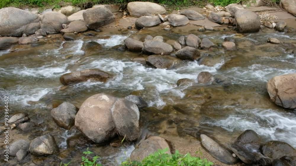 Close up.Pure fresh water flowing in forest with brown rocks. Close up.Pure fresh water flowing in forest with brown rocks.
