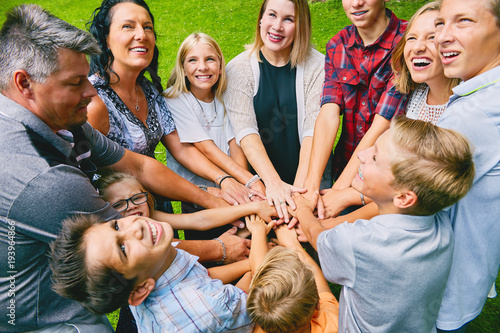 Happy family with nine children heaping hands