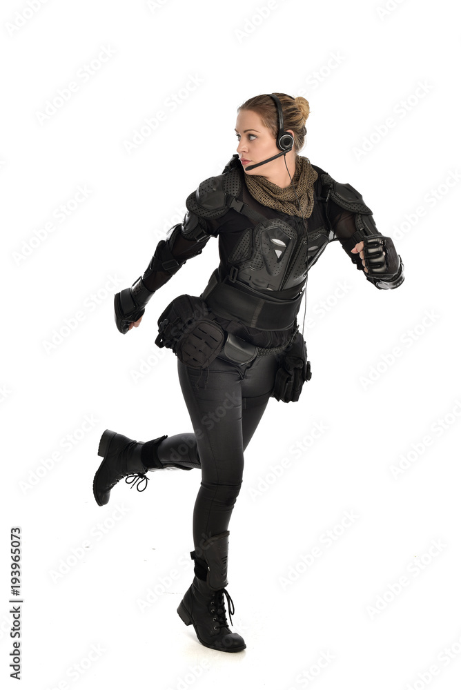 full length portrait of female soldier wearing black tactical armour, isolated on white studio background. full length portrait of female soldier wearing black tactical armour, isolated on white studio background.