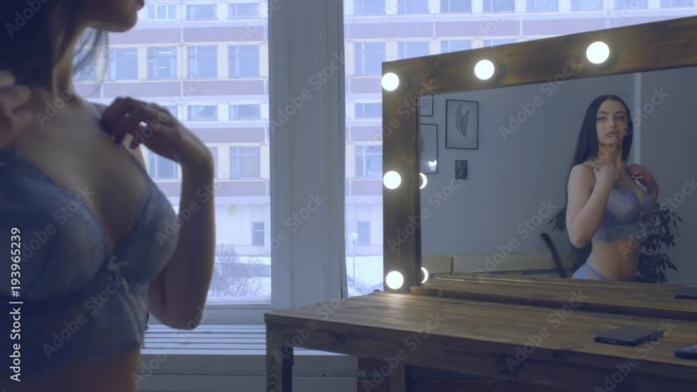 sexy brunette in front of a mirror sexy brunette in front of a mirror