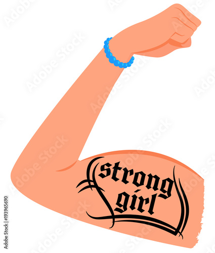 Arm of a strong female with a tattoo "strong girl"