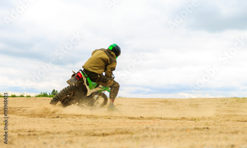 Fototapeta Naklejka Na Ścianę i Meble -  Close-up of mountain motocross race in dirt track in day time.