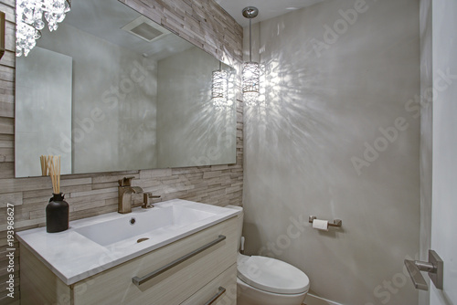 Contemporary bathroom design with taupe linear tiles accent wall