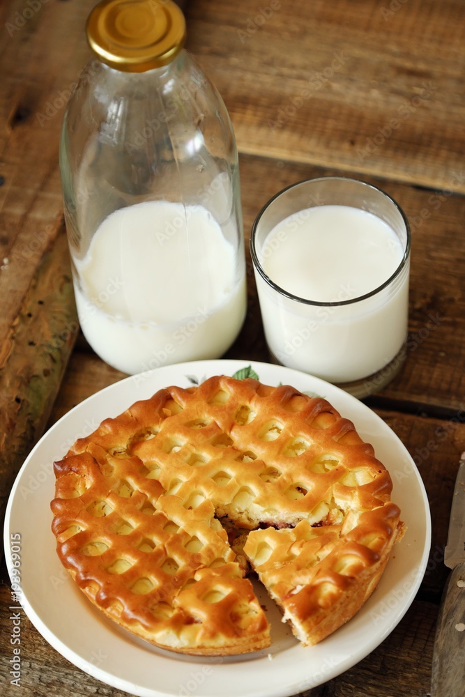 Fresh baking cheesecake and milk on the table Fresh baking cheesecake and milk on the table