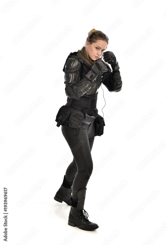 full length portrait of female soldier wearing black tactical armour, isolated on white studio background. full length portrait of female soldier wearing black tactical armour, isolated on white studio background.