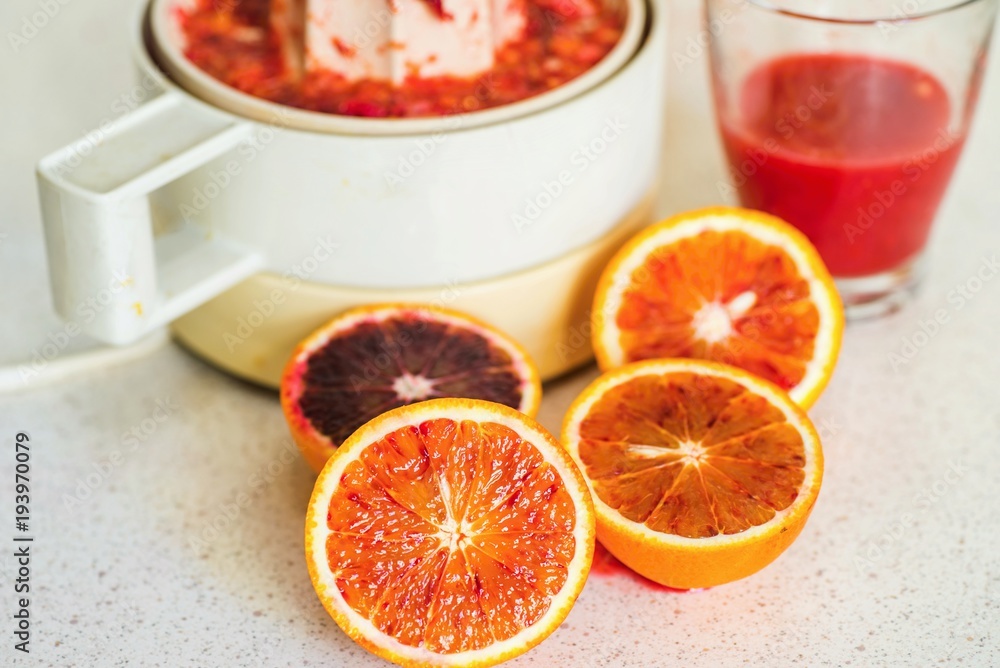 Sliced red oranges,juice and juicer. Sliced red oranges,juice and juicer.