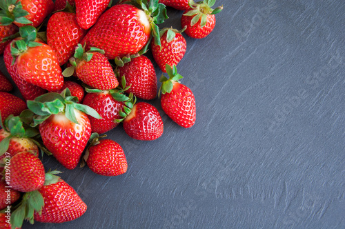 Fresh strawberries on a gray background with copy space