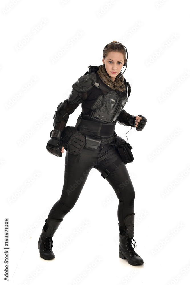 full length portrait of female soldier wearing black tactical armour, isolated on white studio background. full length portrait of female soldier wearing black tactical armour, isolated on white studio background.