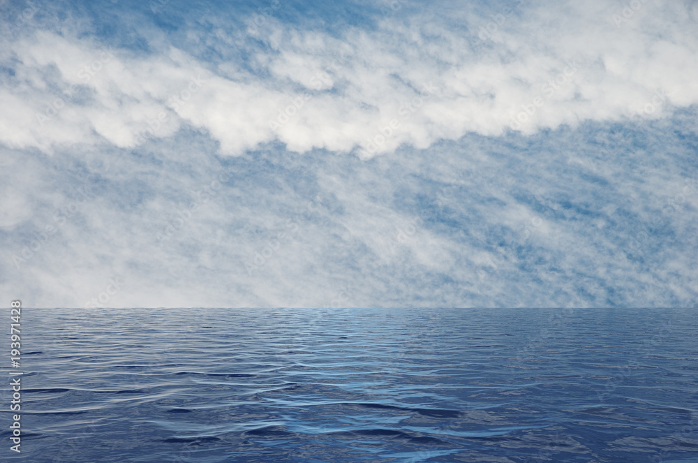Calm sea with ripples leading to a blue sky with white clouds Calm sea with ripples leading to a blue sky with white clouds
