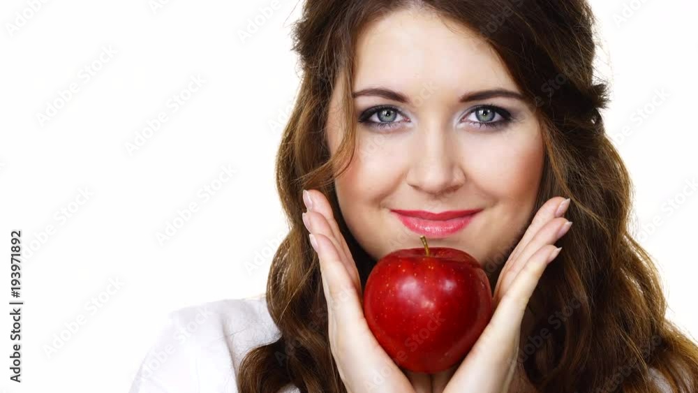 Woman holding red apple fruit in hand close to face,smiling, isolated on white. Healthy eating, high fibre diet concept. Woman holding red apple fruit in hand close to face,smiling, isolated on white. Healthy eating, high fibre diet concept.