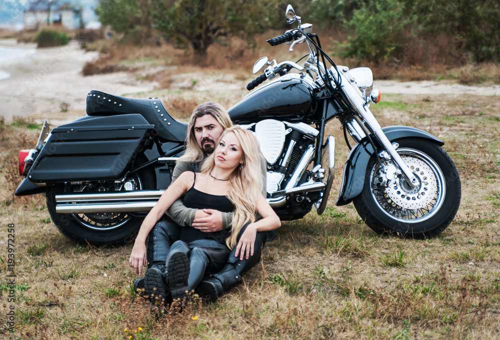 Naklejka premium Couple of bikers have relax on the beach