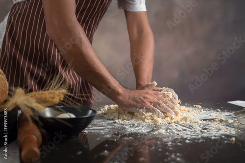 Chef hipster stylish kneads dough for bread on wooden board © kaiskynet
