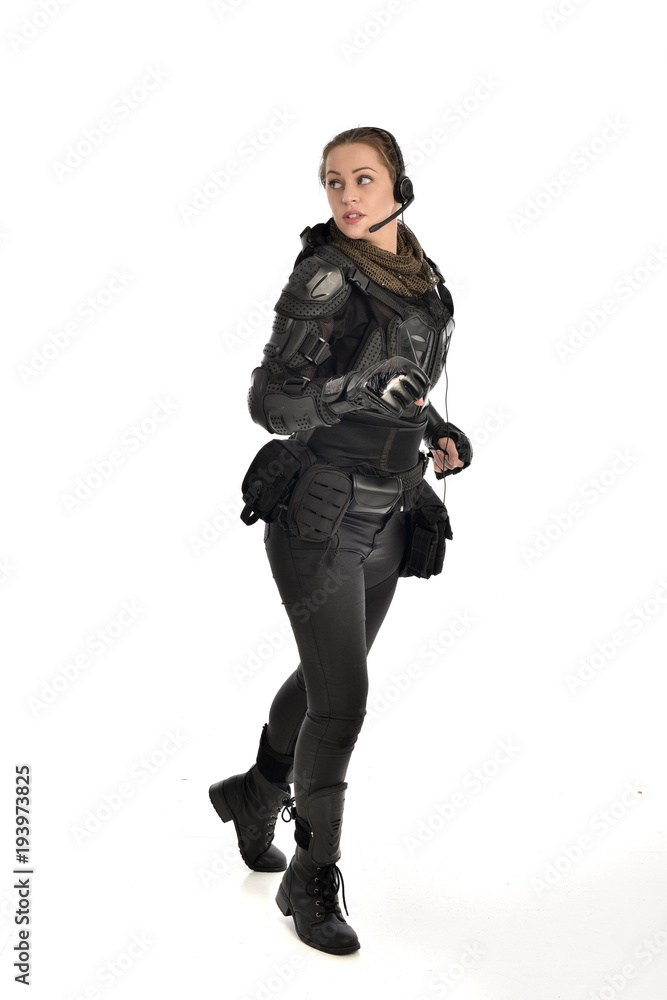full length portrait of female soldier wearing black tactical armour, isolated on white studio background. full length portrait of female soldier wearing black tactical armour, isolated on white studio background.