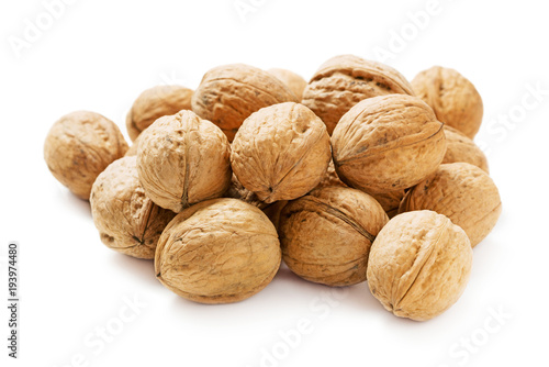 heap of walnuts in shell isolated on white background